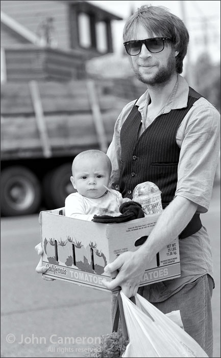 baby in a tomato box at the salt spring market